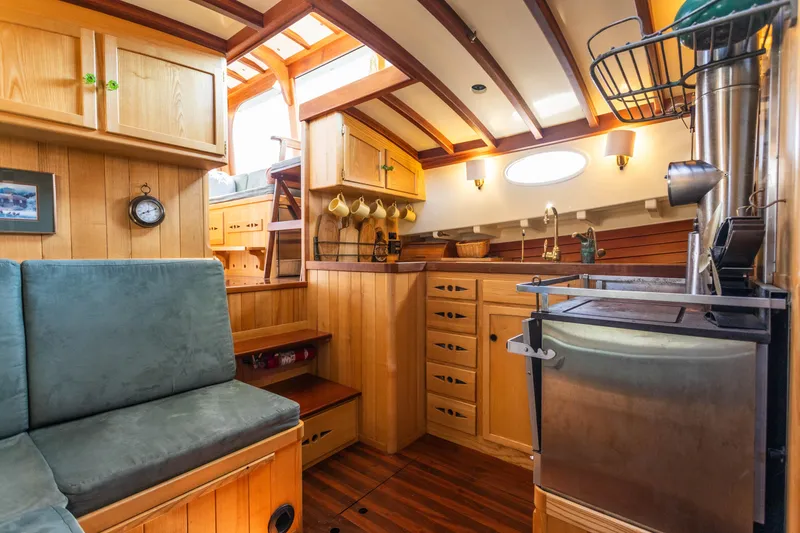 Slide: The Image of Interior of 2009 Custom Gartside Downeast Cruiser with wooden cabinetry and cozy seating. - 15