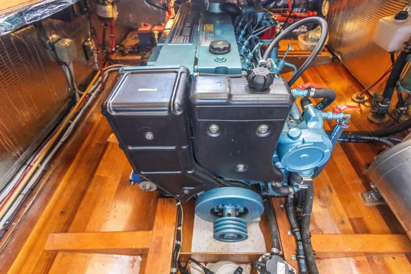 Slide: The Image of 2009 Custom Gartside Downeast Cruiser engine room with well-maintained marine engine. - 28