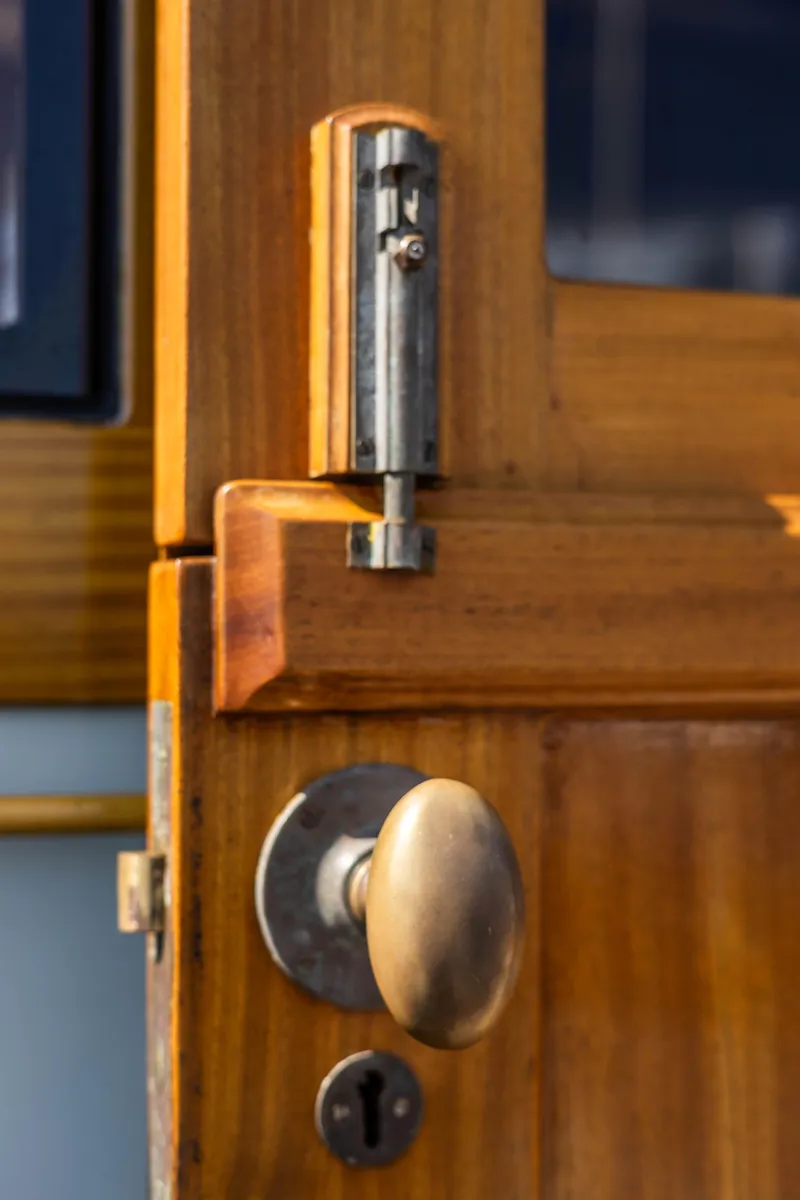 Slide: The Image of Close-up of a wooden door with brass handle on a 2009 Custom Gartside Downeast Cruiser. - 30
