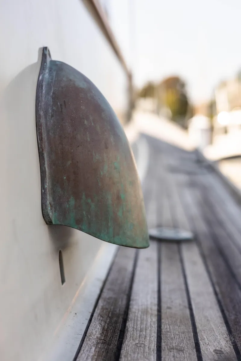 Slide: The Image of Close-up of 2009 Custom Gartside Downeast Cruiser's weathered metal fixture on wooden deck. - 38