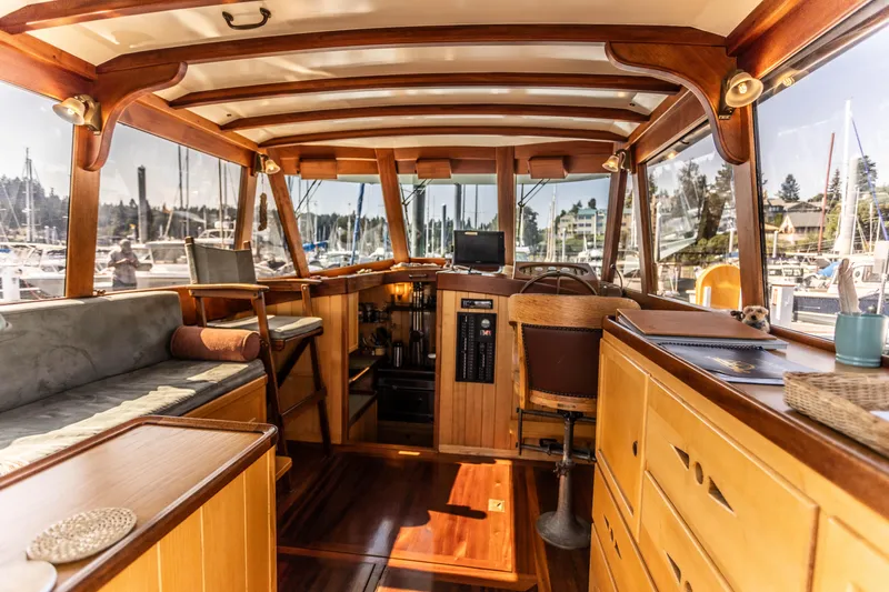 Slide: The Image of Interior of 2009 Custom Gartside Downeast Cruiser with wooden finishes and marina view. - 5