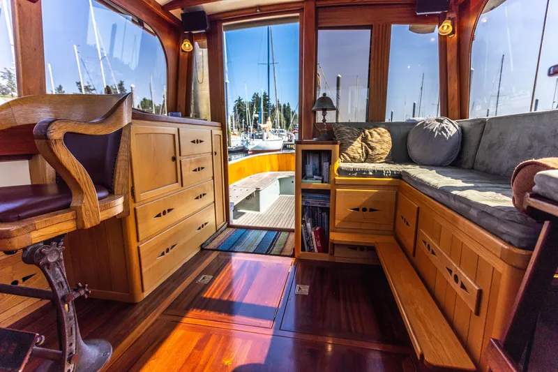Slide: The Image of Interior of 2009 Custom Gartside Downeast Cruiser with wooden cabinetry and seating, docked at marina. - 9