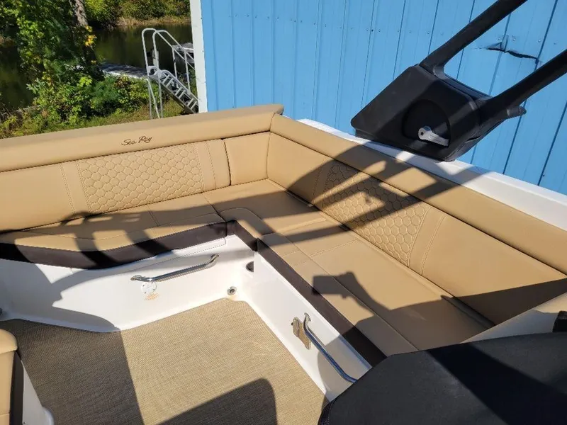 Slide: The Image of 2024 Sea Ray SDX 270 boat with tan leather seating and blue exterior. - 12
