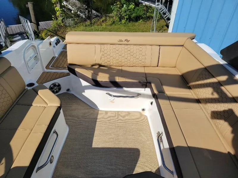 Slide: The Image of 2024 Sea Ray SDX 270 boat interior with tan seating and spacious layout. - 13