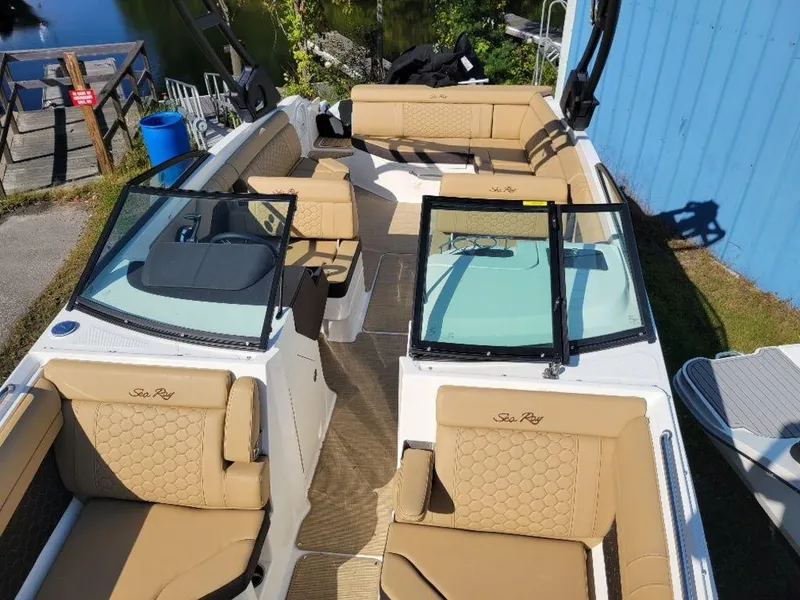 Slide: The Image of 2024 Sea Ray SDX 270 boat with tan leather seating and open deck layout. - 14