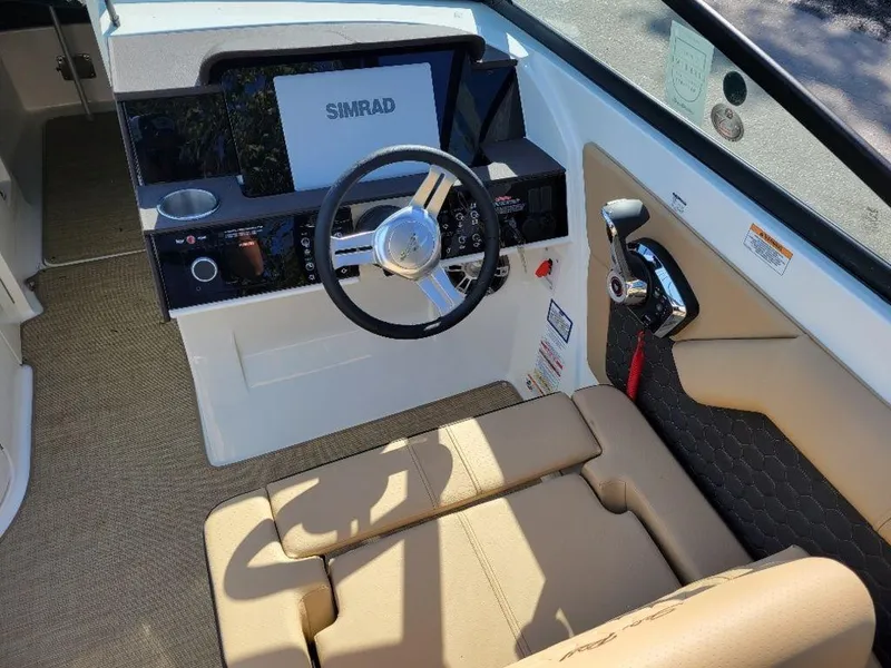 Slide: The Image of 2024 Sea Ray SDX 270 boat cockpit with steering wheel and Simrad display. - 15