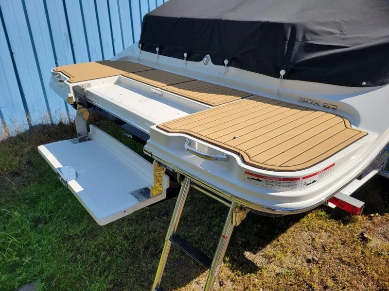 Slide: The Image of 2024 Sea Ray SDX 270 boat with extended swim platform and ladder. - 16
