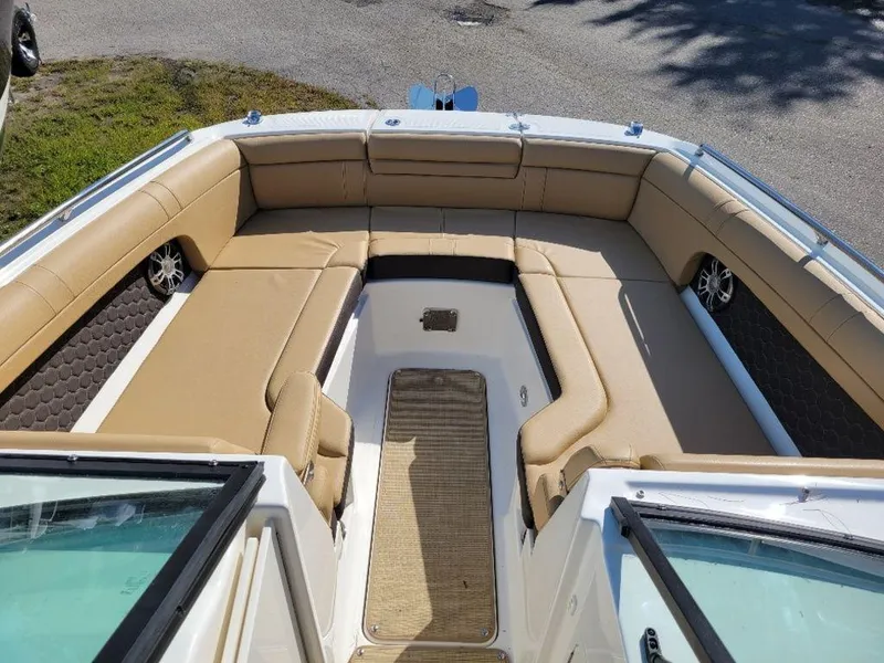 Slide: The Image of 2024 Sea Ray SDX 270 boat with spacious tan seating and modern design. - 17