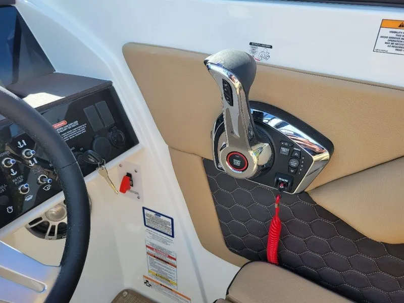 Slide: The Image of 2024 Sea Ray SDX 270 boat control panel and throttle. - 18