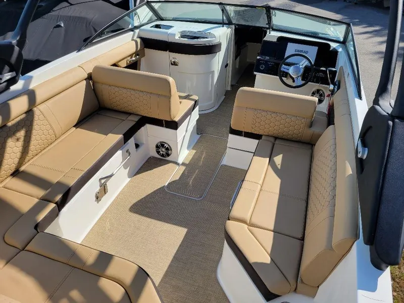 Slide: The Image of 2024 Sea Ray SDX 270 boat interior with tan seating and modern dashboard. - 20