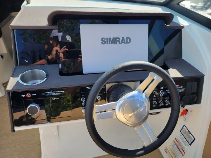 Slide: The Image of 2024 Sea Ray SDX 270 helm with Simrad display and modern controls. - 3