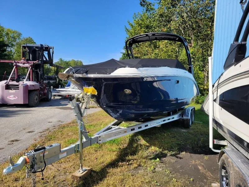 Slide: The Image of 2024 Sea Ray SDX 270 boat on a trailer in a yard. - 7