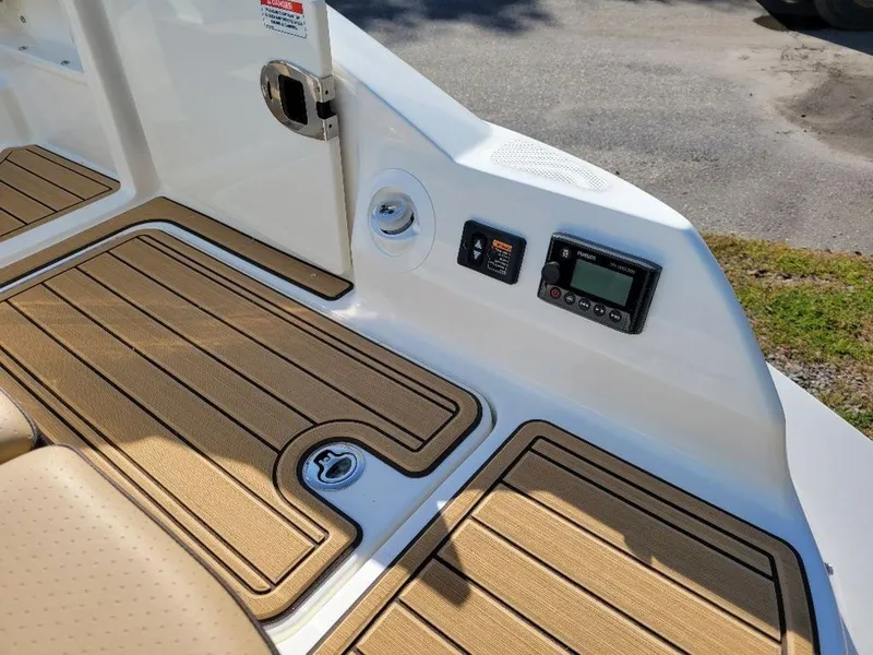 Slide: The Image of 2024 Sea Ray SDX 270 boat deck with control panel and teak flooring. - 8