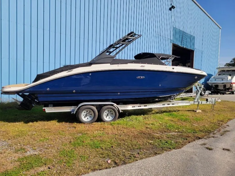 Slide: The Image of 2024 Sea Ray SDX 270 boat on a trailer outside a blue warehouse. - 9