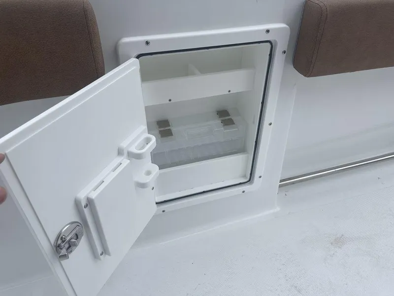 Slide: The Image of 2024 Sea Hunt Gamefish 27 FS storage compartment with open door. - 12