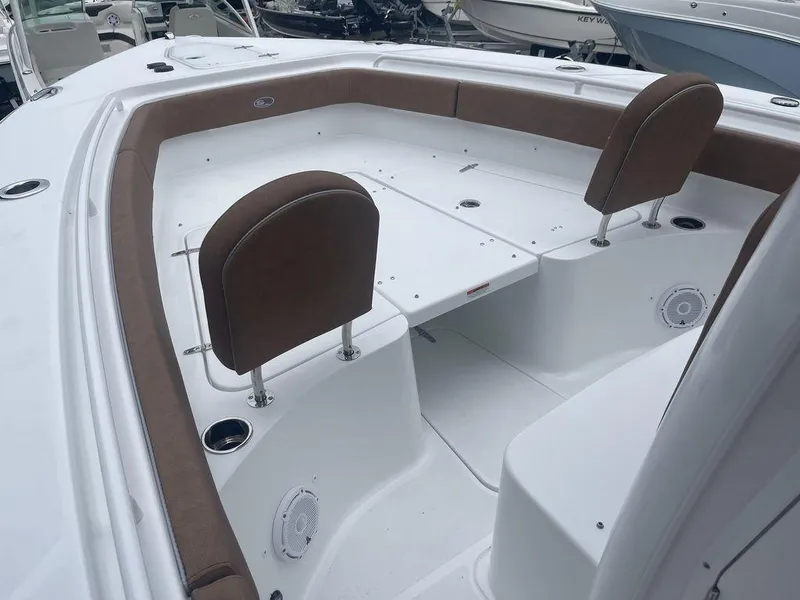Slide: The Image of 2024 Sea Hunt Gamefish 27 FS boat interior with cushioned seating and storage compartments. - 14
