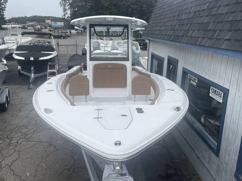 Slide: The Image of 2024 Sea Hunt Gamefish 27 FS boat on display at a marina. - 16