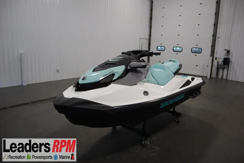 The Image of 2025 Sea-Doo GTI™ 130 jet ski in showroom, featuring sleek design and mint green accents. - 1