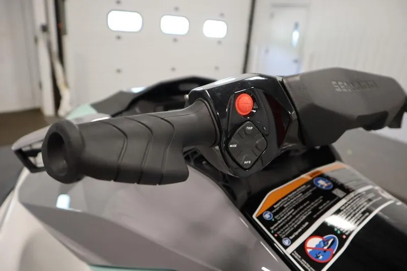 Slide: The Image of 2025 Sea-Doo GTI 130 handlebar with control buttons in a garage setting. - 13