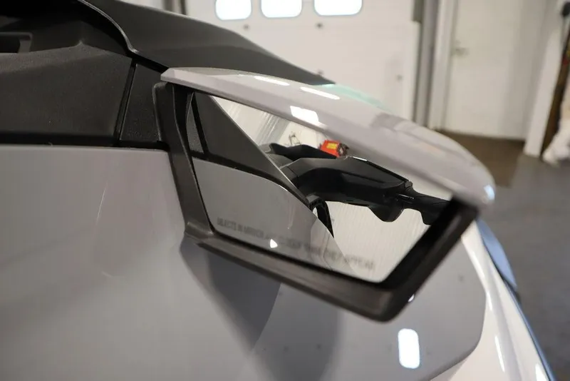 Slide: The Image of 2025 Sea-Doo GTI 130 side mirror close-up in a garage setting. - 15