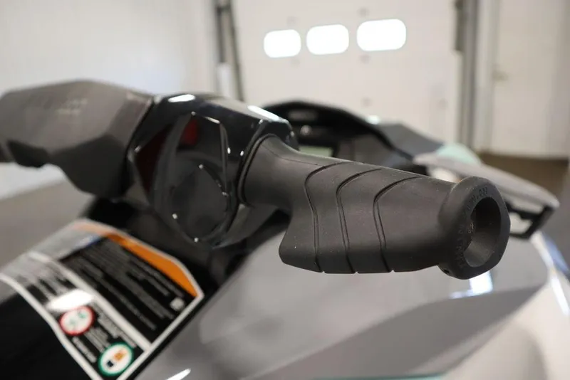 Slide: The Image of Close-up of 2025 Sea-Doo GTI 130 handlebar grip in a garage setting. - 17