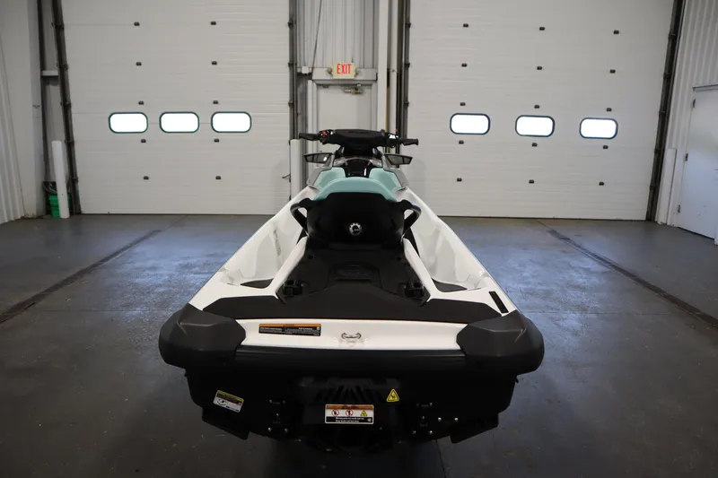 Slide: The Image of 2025 Sea-Doo GTI™ 130 jet ski in a garage, rear view. - 4