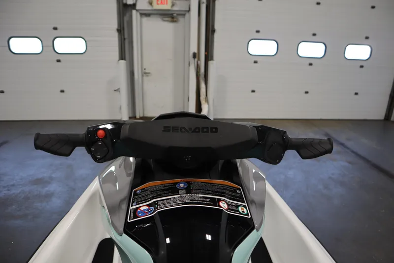 Slide: The Image of 2025 Sea-Doo GTI™ 130 handlebars in a garage setting. - 7