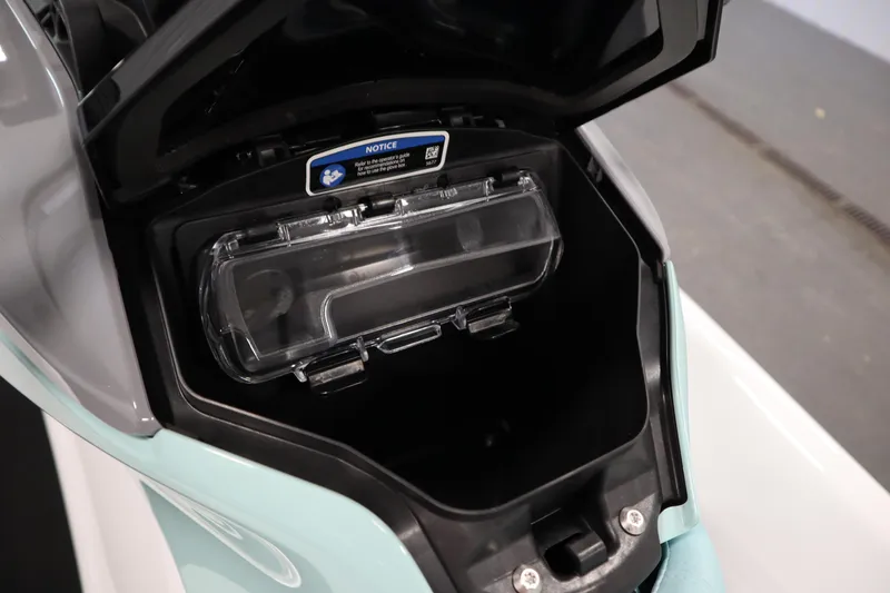 Slide: The Image of 2025 Sea-Doo GTI™ 130 storage compartment with open lid, showcasing interior space. - 9