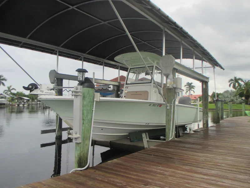 The Image of 2019 Sportsman 267 Masters boat docked under a covered marina. - 0