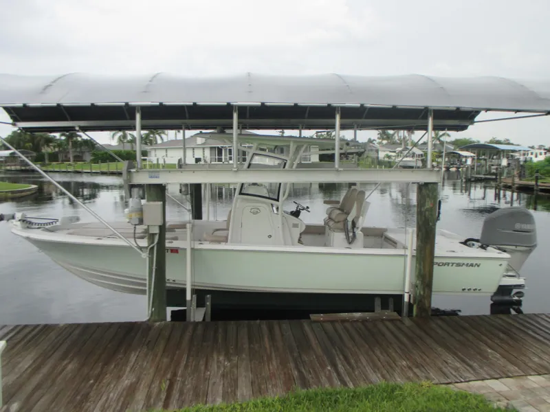 Slide: The Image of 2019 Sportsman 267 Masters boat docked under a covered lift. - 1