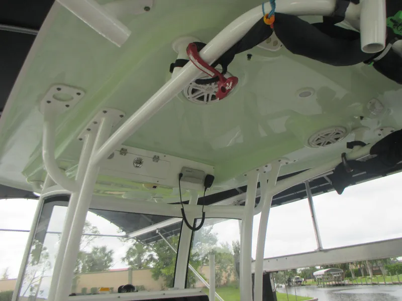 Slide: The Image of 2019 Sportsman 267 Masters boat interior, featuring overhead storage and speakers. - 10