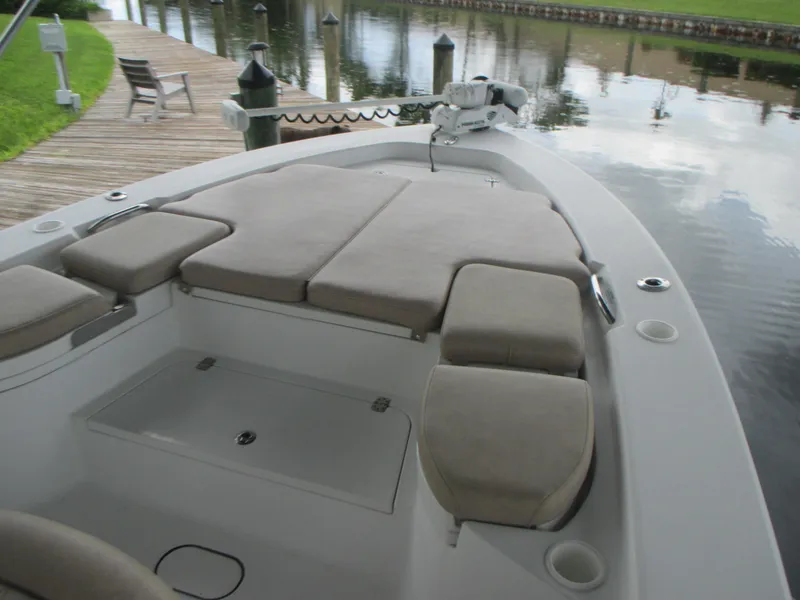 Slide: The Image of 2019 Sportsman 267 Masters boat with cushioned seating at dock. - 13