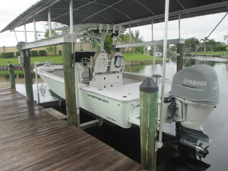 Slide: The Image of 2019 Sportsman 267 Masters boat docked under a covered slip. - 2