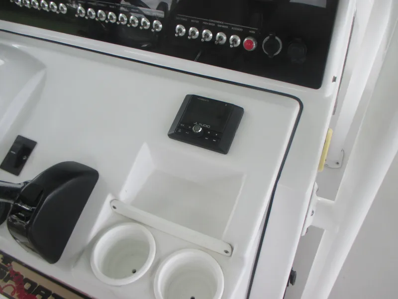 Slide: The Image of Control panel of a 2019 Sportsman 267 Masters boat with cup holders and electronic display. - 5