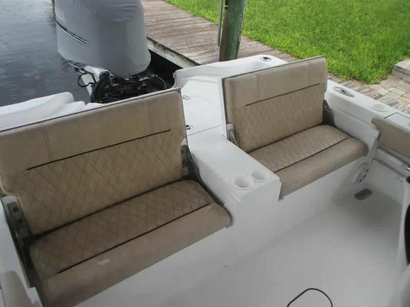 Slide: The Image of 2019 Sportsman 267 Masters boat with tan cushioned seating and cup holders. - 9