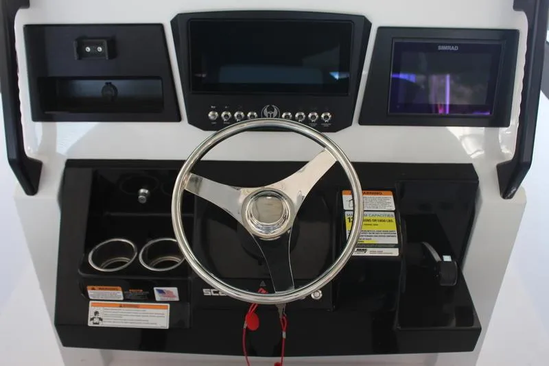 Slide: The Image of 2023 Scarab 255 ID boat dashboard with steering wheel and control panel. - 7