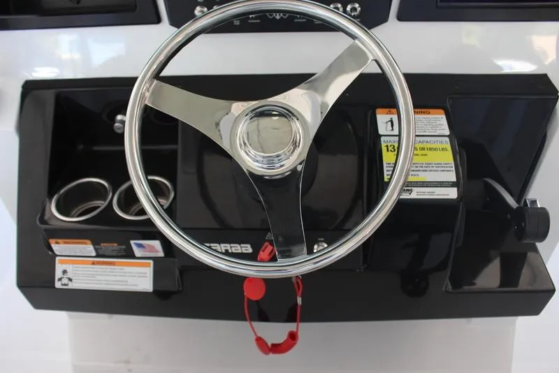 Slide: The Image of 2023 Scarab 255 ID boat steering wheel and dashboard controls. - 9