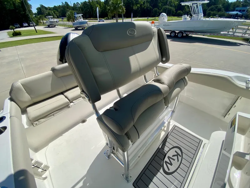 Slide: The Image of 2024 Key West 219 FS boat interior with cushioned seating and helm station. - 10