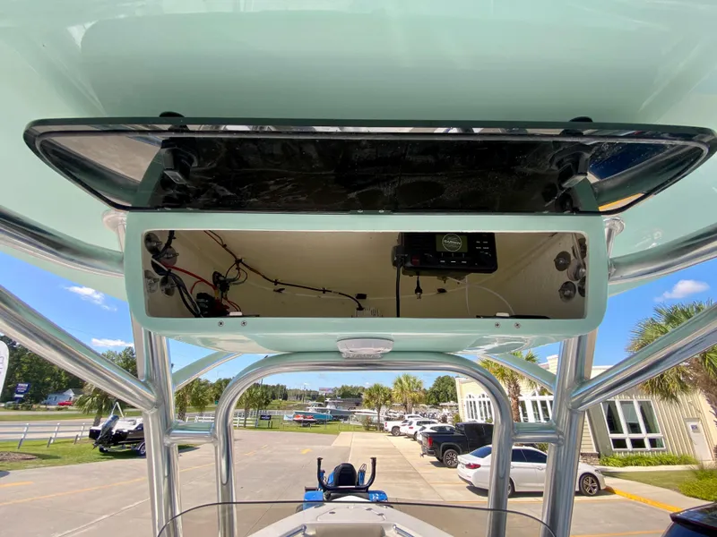 Slide: The Image of 2024 Key West 219 FS boat console with electronics and storage compartment. - 14