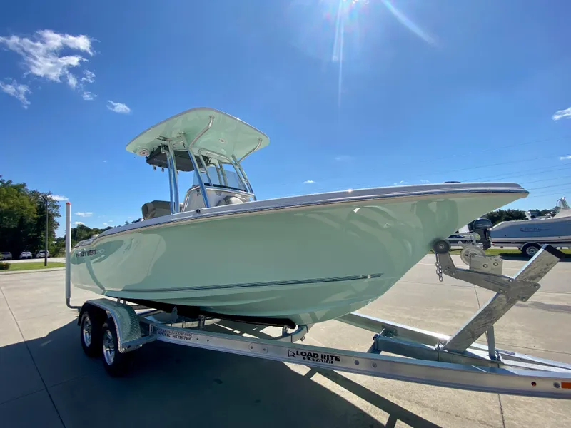 Slide: The Image of 2024 Key West 219 FS boat on a trailer under a clear blue sky. - 2