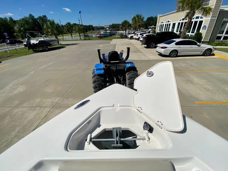 Slide: The Image of 2024 Key West 219 FS boat on a trailer in a parking lot. - 23