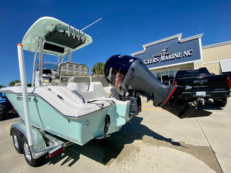 Slide: The Image of 2024 Key West 219 FS boat at dealership, rear view with Yamaha outboard motor. - 3