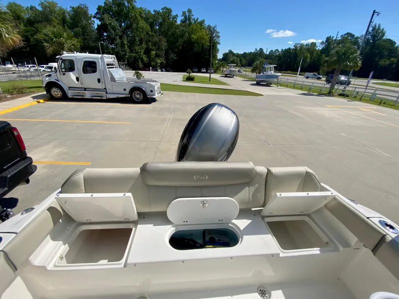 Slide: The Image of 2024 Key West 219 FS boat with outboard motor in parking lot. - 9
