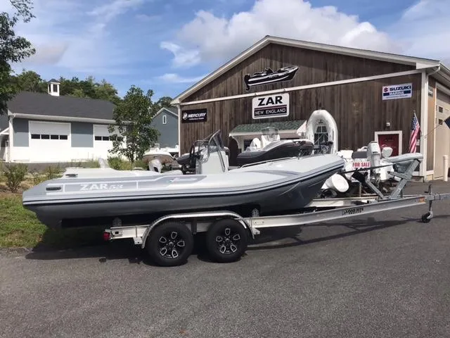 Slide: The Image of 2024 Zar Formenti 53 SPC boat on a trailer outside a dealership. - 3