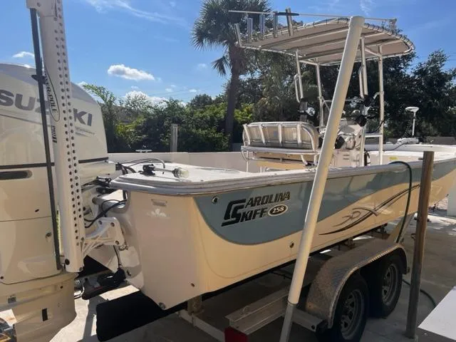 Slide: The Image of 2019 Carolina Skiff 258 DLV boat on trailer with Suzuki outboard motor. - 10