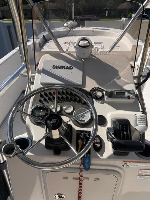 Slide: The Image of 2019 Carolina Skiff 258 DLV boat console with Simrad electronics and steering wheel. - 11