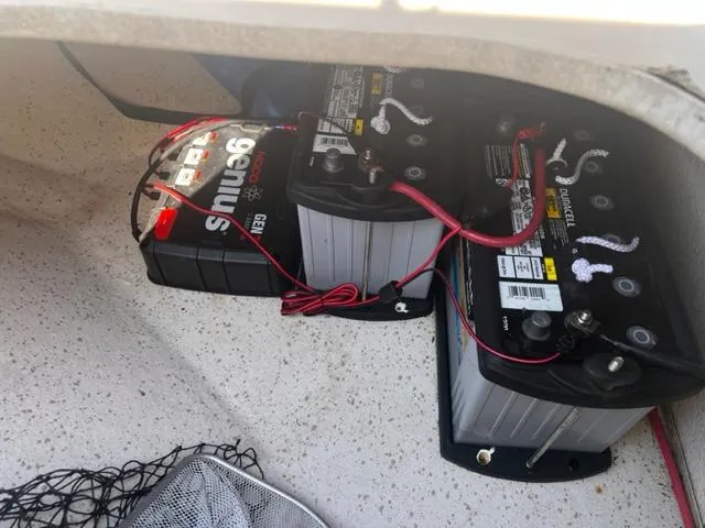 Slide: The Image of 2019 Carolina Skiff 258 DLV boat battery compartment with connected batteries. - 14