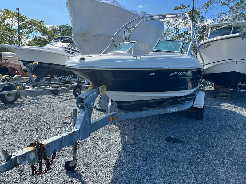 The Image of 2006 Sea Ray 205 Sport boat on trailer in a marina setting. - 0
