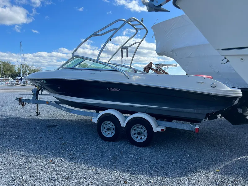 Slide: The Image of 2006 Sea Ray 205 Sport boat on trailer under blue sky. - 1