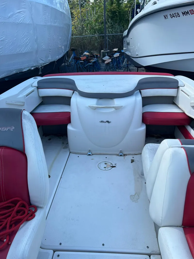 Slide: The Image of 2006 Sea Ray 205 Sport boat interior with red and white seating. - 11